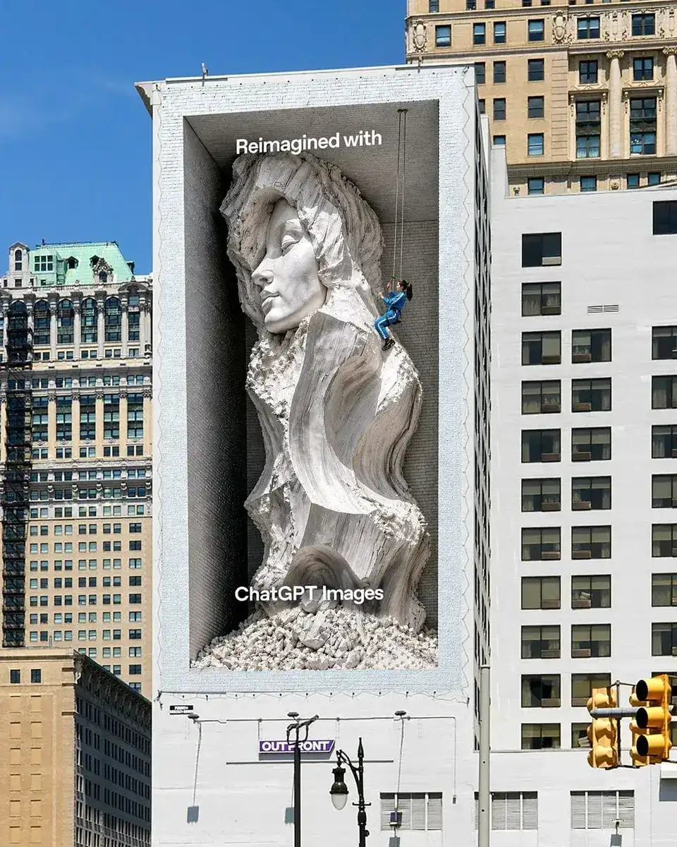 Affichage géant en trompe-l'oeil signé OpenAI dévoilé le 15 juin 2026 sur la façade d'un immeuble de Detroit, sculpture monumentale de femme aux longs cheveux ondulés générée par ChatGPT Images 2.0 émergeant littéralement d'une niche creusée dans le bâtiment blanc, ouvrier en harnais bleu en rappel le long de la sculpture, panneau OUTFRONT visible en bas, slogan Reimagined with ChatGPT Images en blanc
