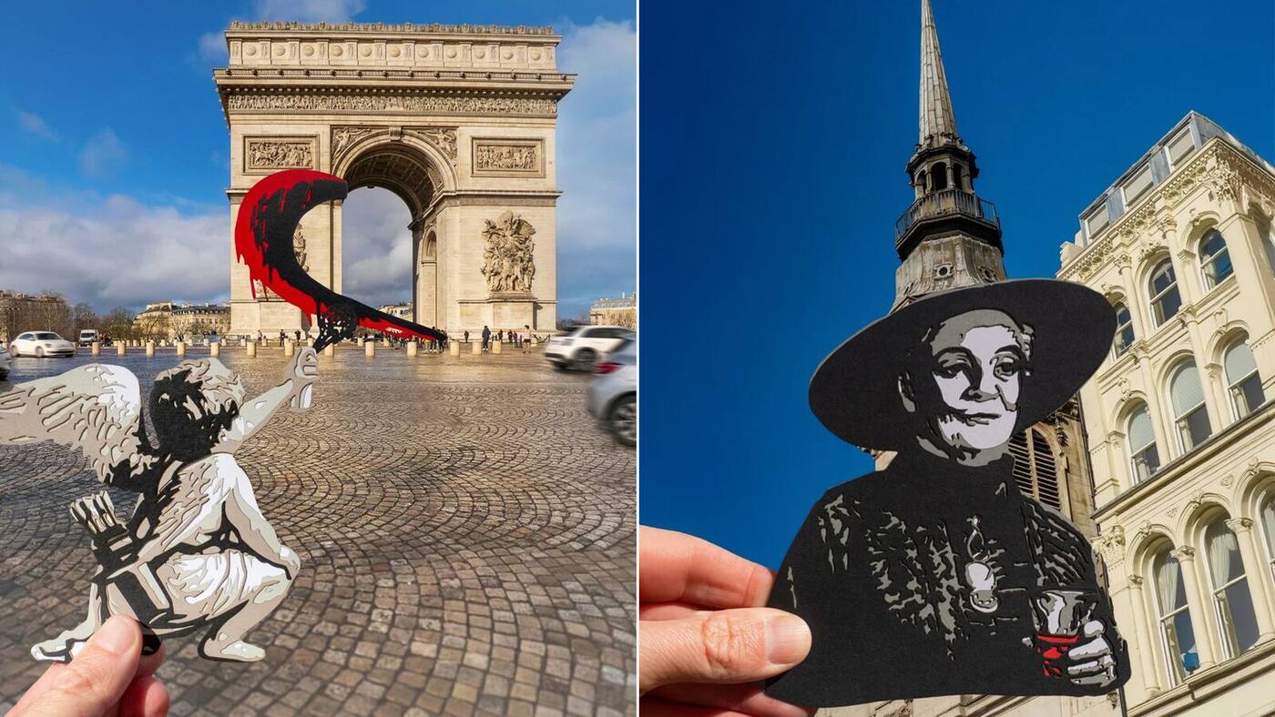 Photographie signée Paperboyo Rich McCor mise en avant le 19 juin 2026, plan large devant l'Arc de Triomphe à Paris baigné de lumière dorée de fin d'après-midi, une main tenue à bout de bras devant l'objectif présente une découpe en papier noir précisément alignée pour transformer l'Arc en cœur géant